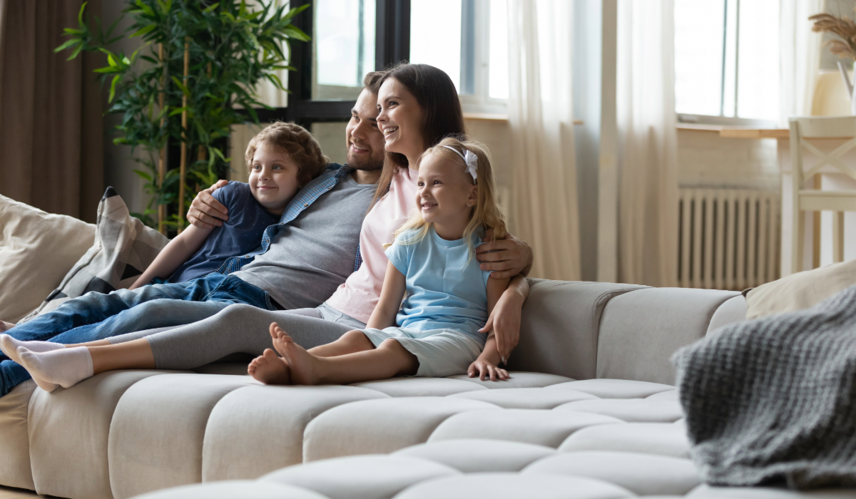 Family relaxing on a stylish modern sofa, enjoying a cozy and inviting living room space with elegant interior design.