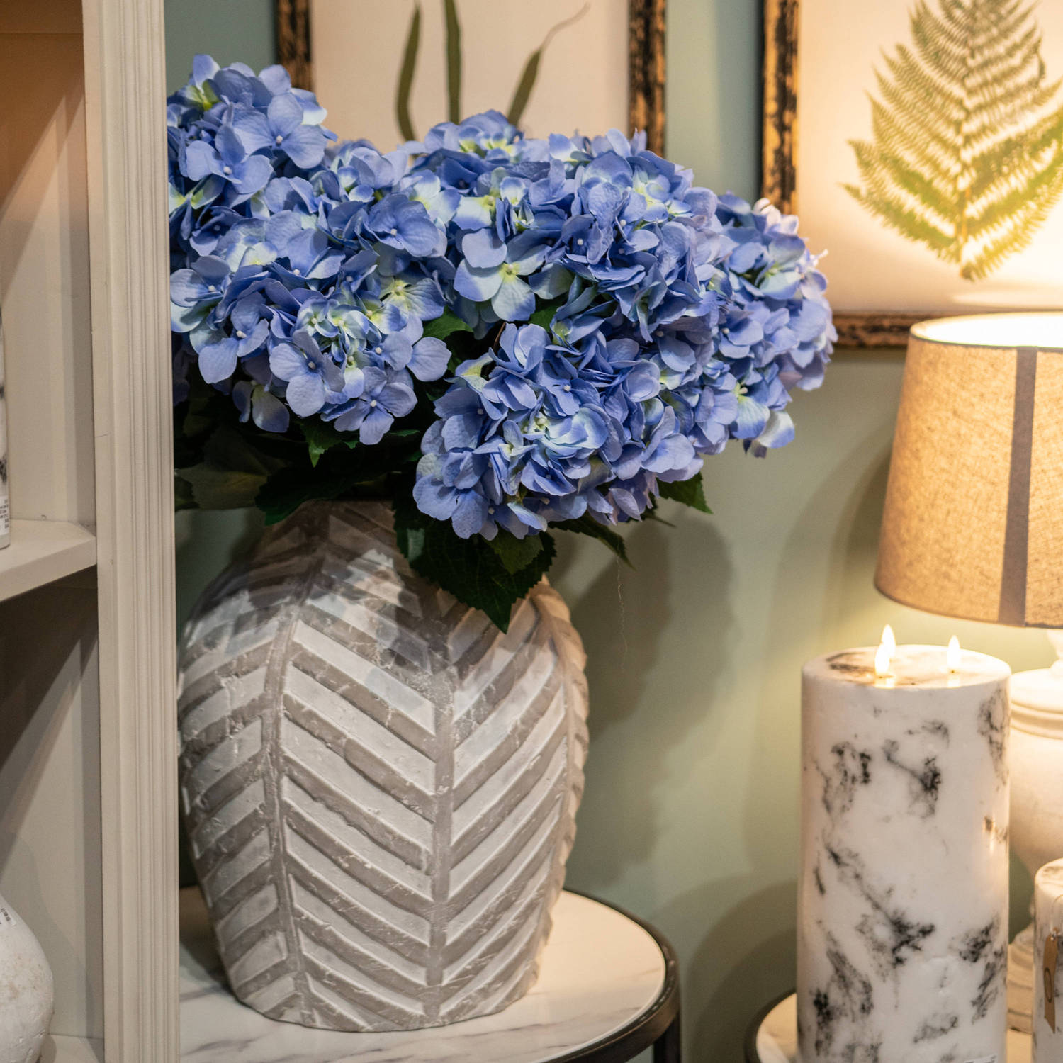 Bloomville Stone Vase with geometric pattern, showcasing blue hydrangeas. Luxury and designer furniture for modern, curated home decor.
