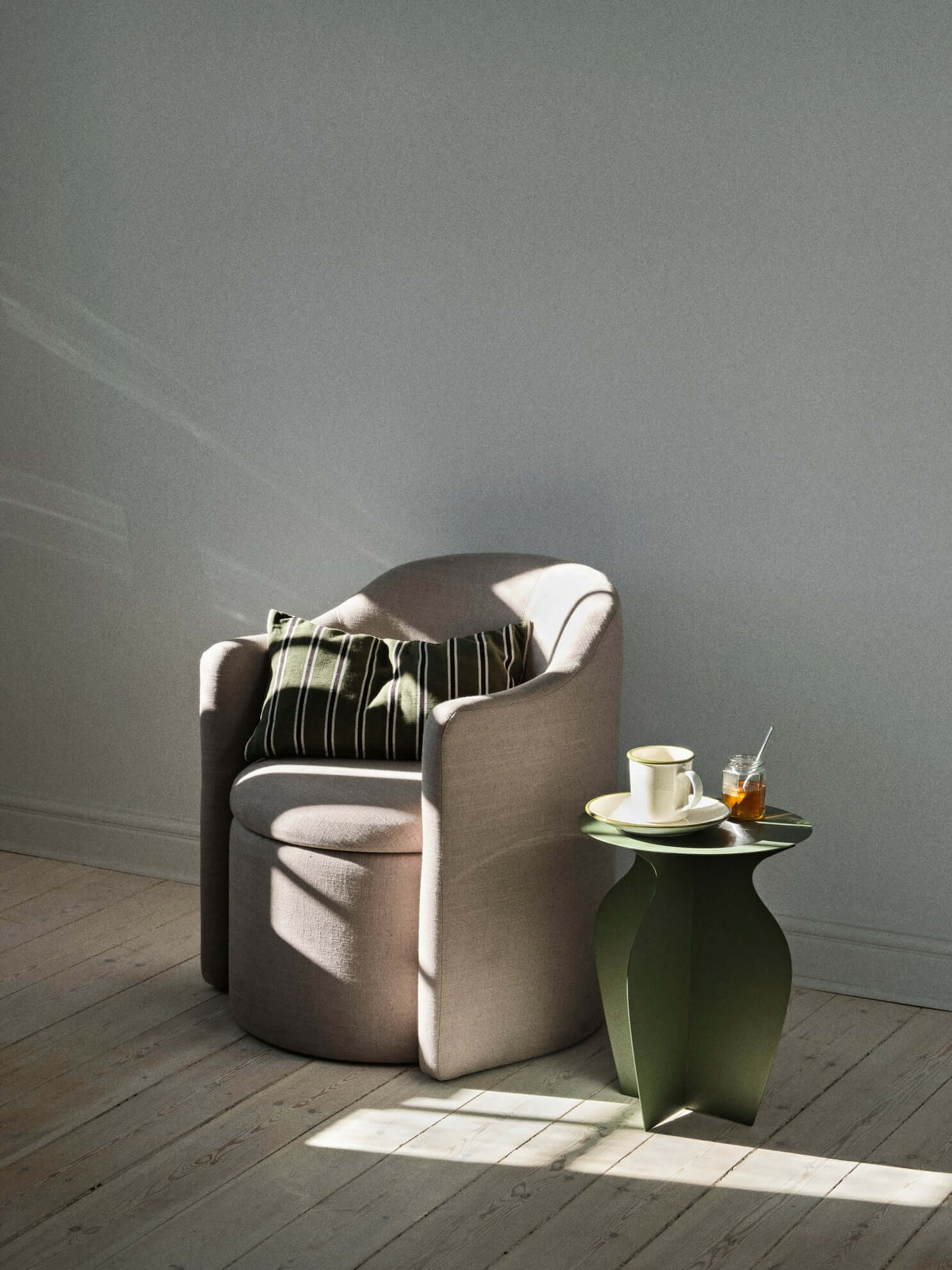 Alt Tag: Pond Armchair in Latte beside green table, showcasing luxury and modern design. Perfect for high-end home decor and curated collections.