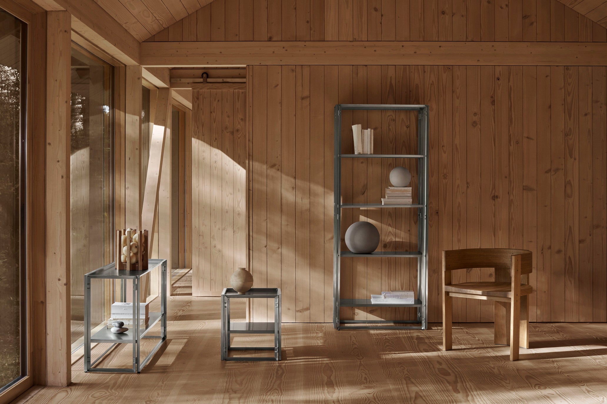 Minimalist wooden room with modern metal shelving and natural light.