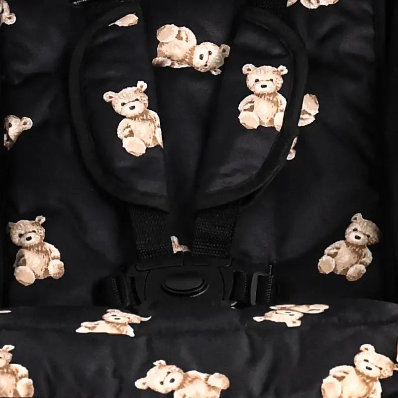 Black stroller seat with teddy bear pattern, emphasizing luxury and modern design for stylish and comfortable baby transport.