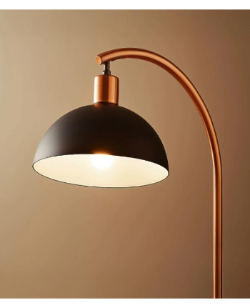 Modern arched floor lamp with black and copper finish, illuminating a warm glow against a soft beige background.