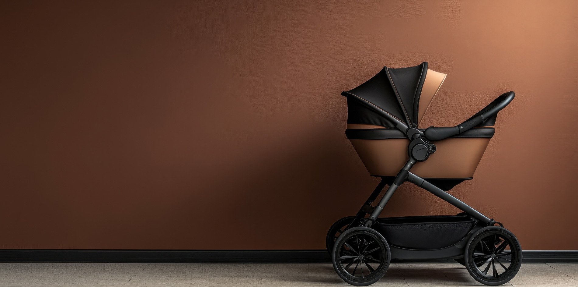 Modern brown and black baby stroller on wheels against a copper-colored wall, showcasing sleek design and functionality.