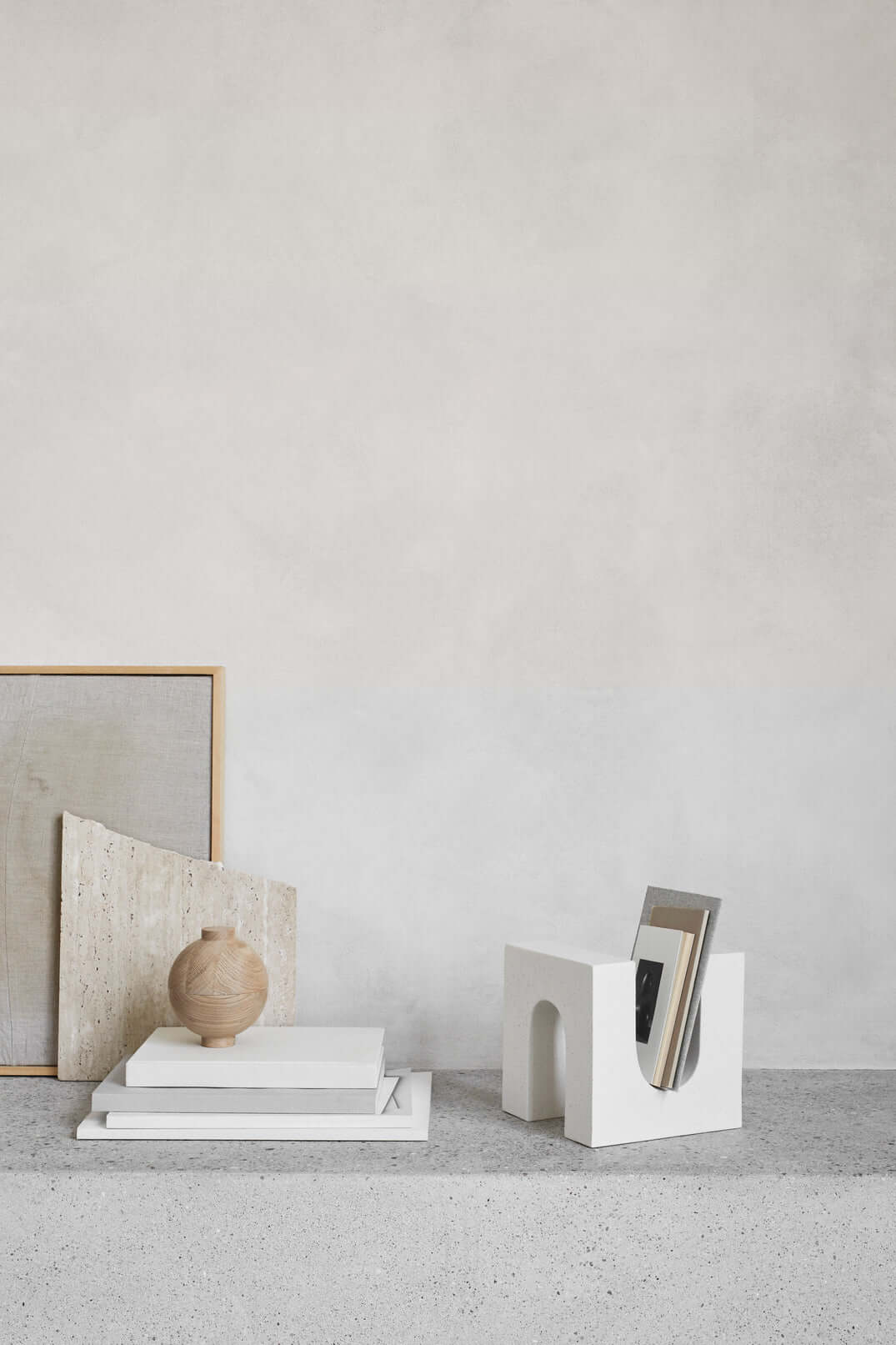 Minimalist decor with geometric sculpture, neutral tones, and modern design objects on a clean surface.