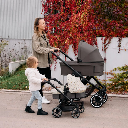 Mother with child using ABC Design Kiddie Ride On 2 Board with stroller — a blend of luxury, designer furniture, and premium home furnishings.