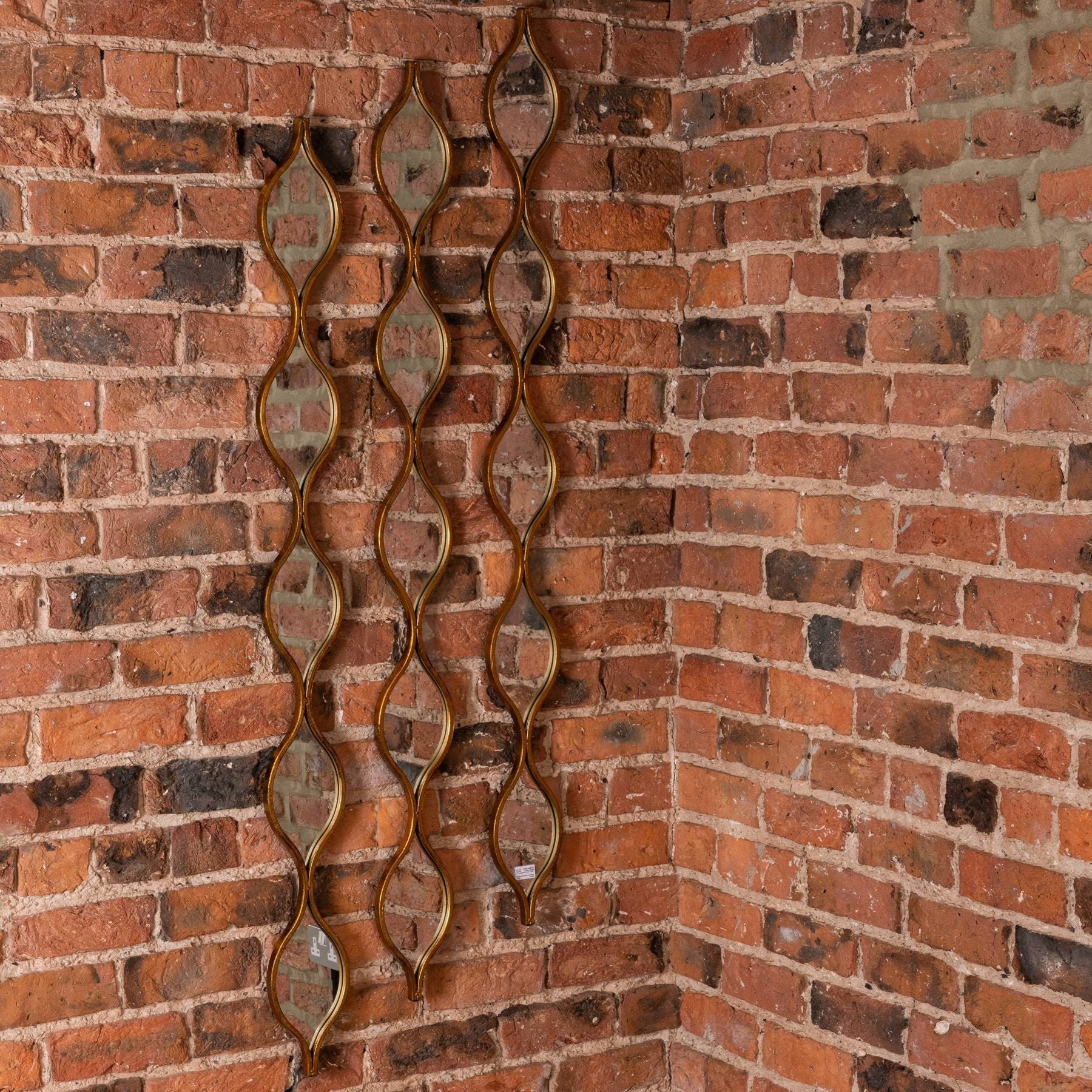 Decorative Hanging Gold Mirror on brick wall – Luxury Furniture, Designer Mirror, Modern Home Decor, Premium Furnishings.