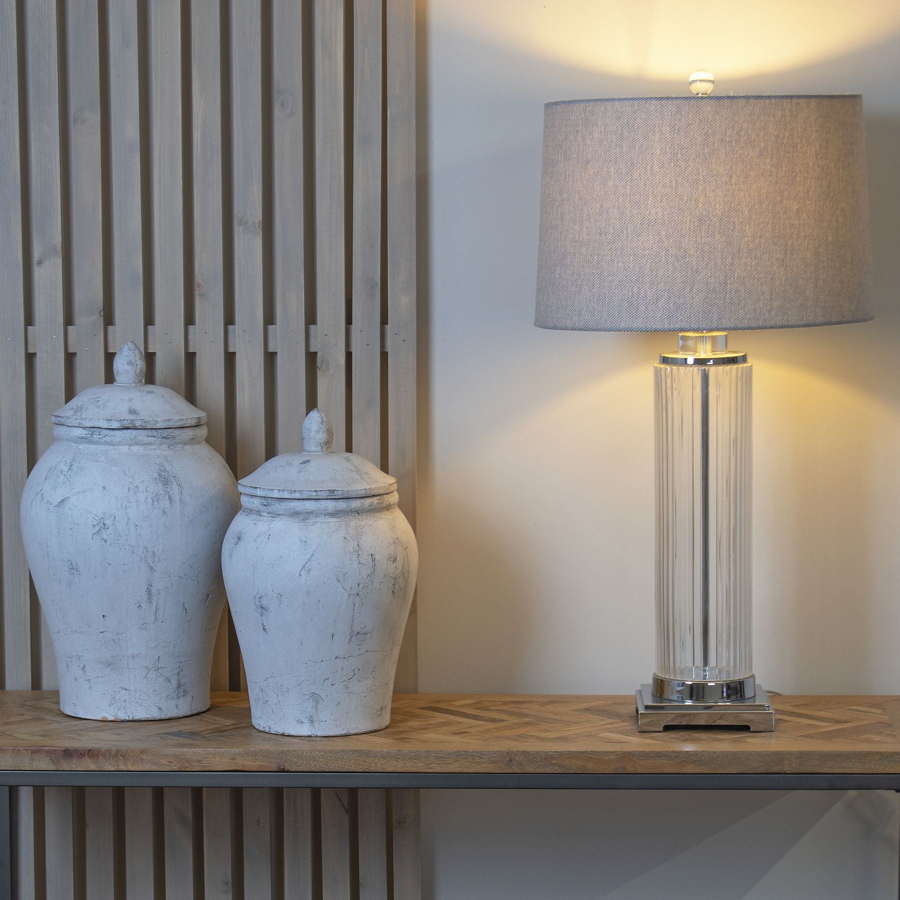Bloomville Stone Ginger Jars on wooden shelf with designer lamp, showcasing luxury, modern furniture and premium home decor pieces.