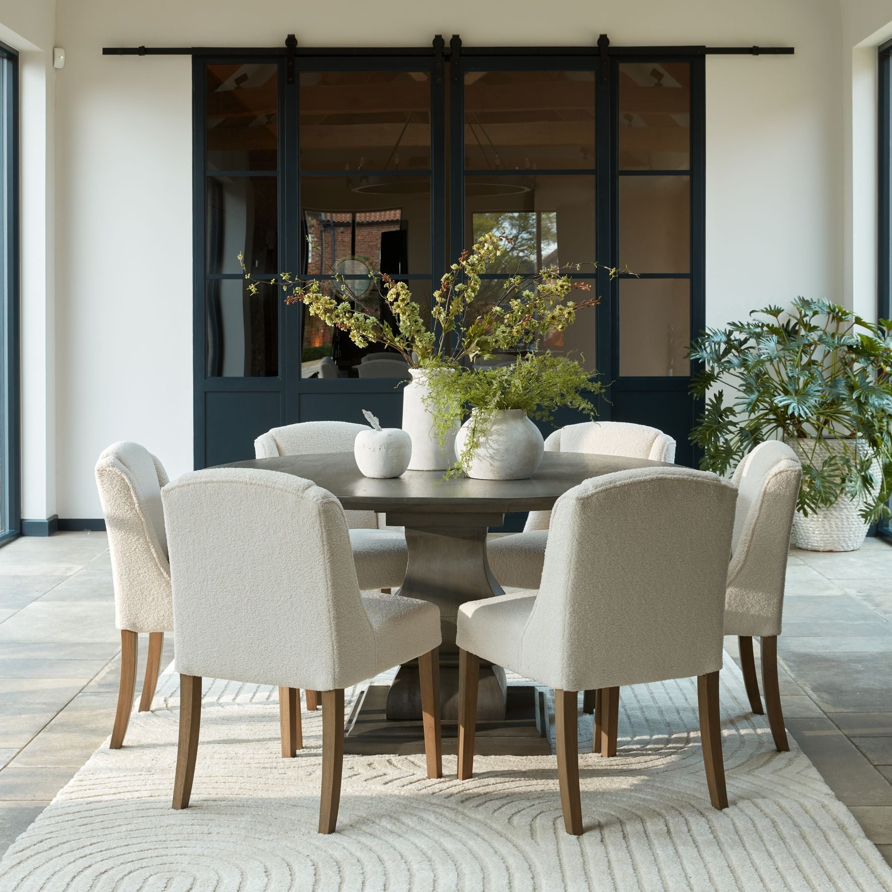 Elegant dining room with luxury table, modern chairs, and designer decor set in a premium home environment; luxury furniture appeal.