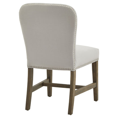 Cobham Grey Dining Chair by [Vendor] – Luxury Designer Furniture with weathered oak frame and grey upholstery adorned with brass studs.