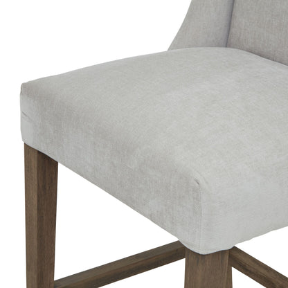 Luxury Compton Grey Barstool with light grey fabric and sturdy wood frame. Modern designer furniture for high-end home décor.