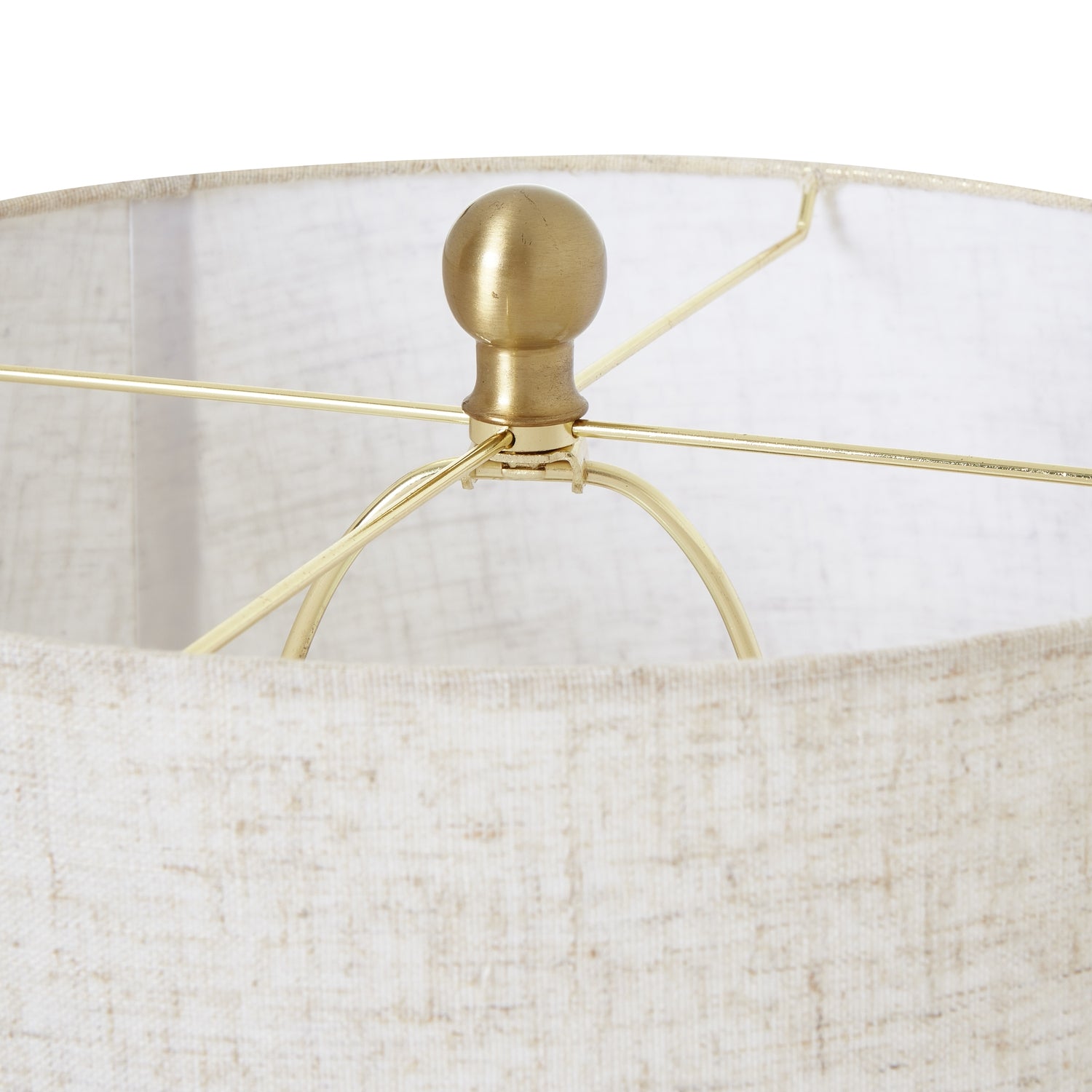 Close-up of White Wash Bulbous Wicker Table Lamp's linen shade and gold finial, epitomizing luxury and modern designer furniture elegance.