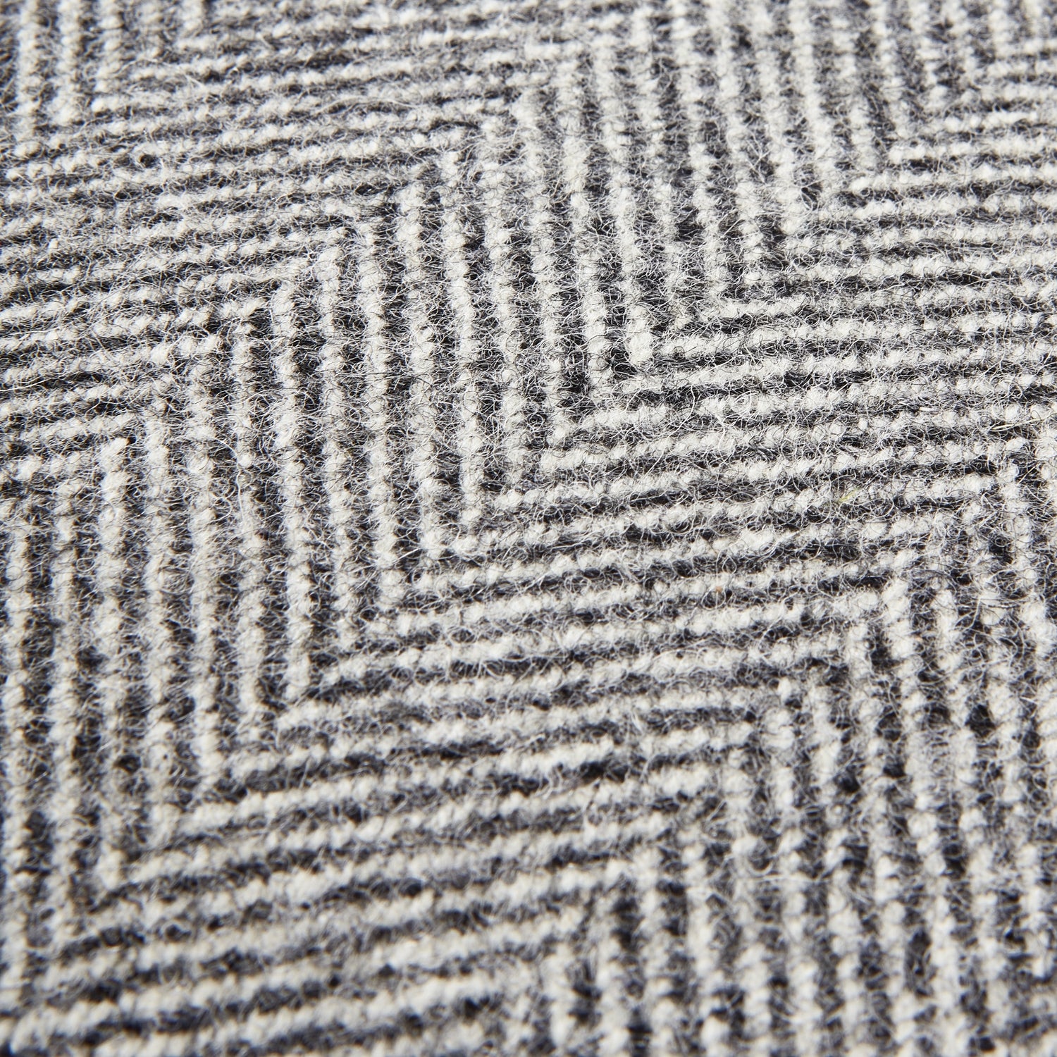 Close-up of Grey Herringbone Pure Wool Cushion, luxury designer furniture, premium modern home decor, curated furniture collection.