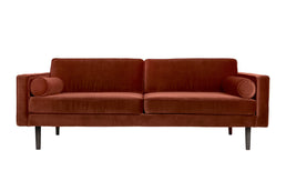 Modern velvet sofa in rich burgundy color with sleek black legs, featuring stylish cylindrical cushions on each armrest.