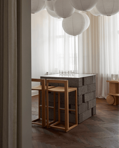 Outline Bar Chair High in minimalist design, crafted from FSC-certified oak, enhancing modern luxury in kitchen decor.