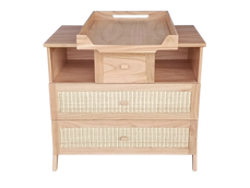 Wooden changing table with two wicker drawers and an upper shelf, designed for nursery storage and easy diapering.