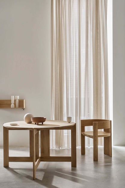 Minimalist dining space featuring the Collector Dining Chair in premium oak, showcasing luxury and modern design. Perfect for high-end decor.