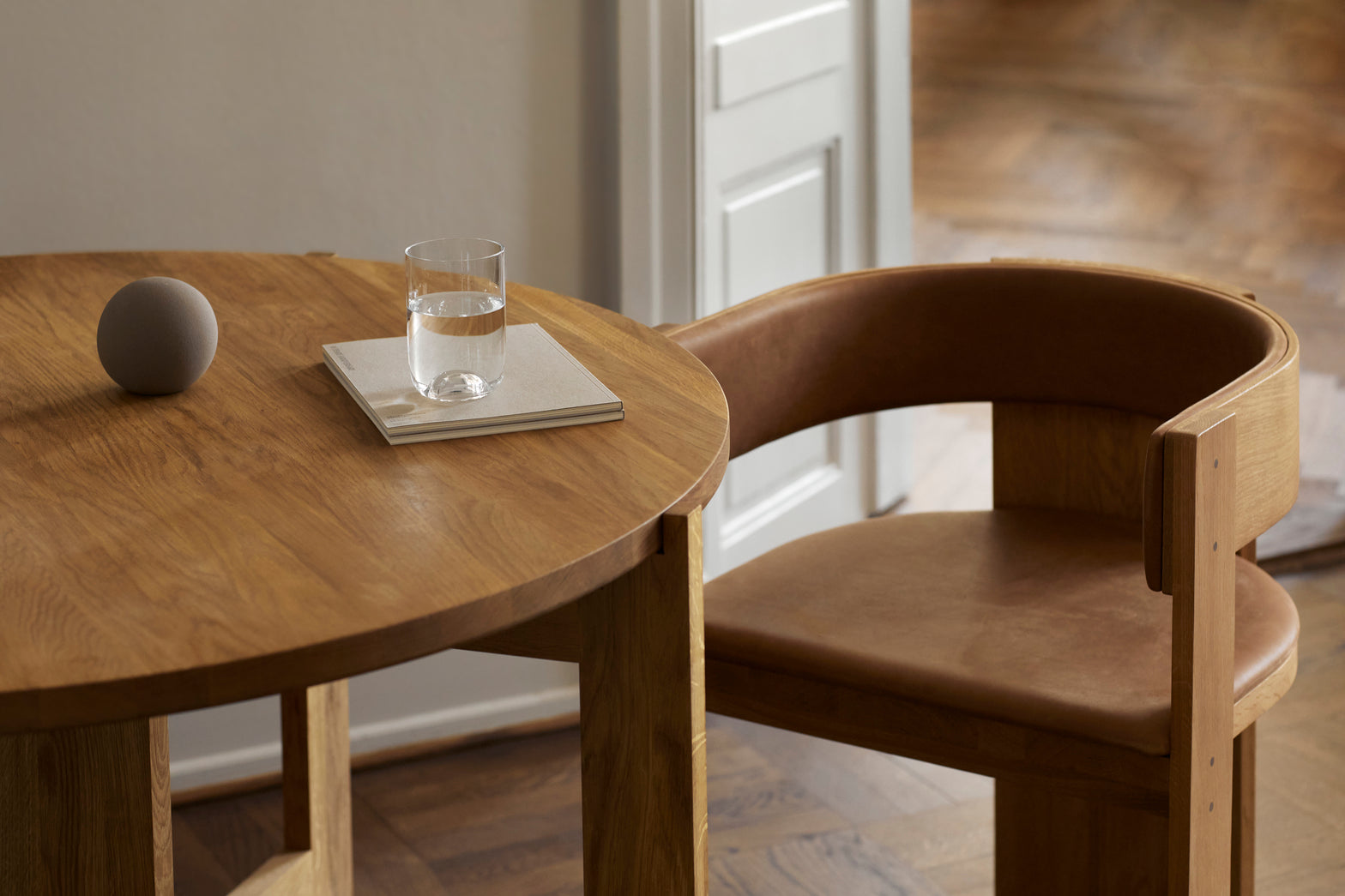 Collector Dining Chair – Luxury and Designer Furniture. Modern oak dining setup with leather chair, ideal for premium home decor.