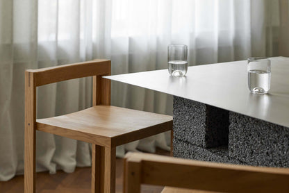 Alt Tag: Outline Bar Chair High in FSC-certified oak, showcasing luxury modern furniture design for high-end interior spaces.