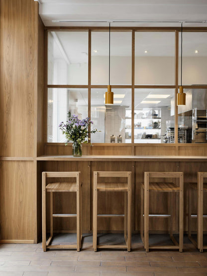Luxury designer Outline Bar Chair High in FSC-certified oak, perfect modern furniture for upscale bar and kitchen decor.