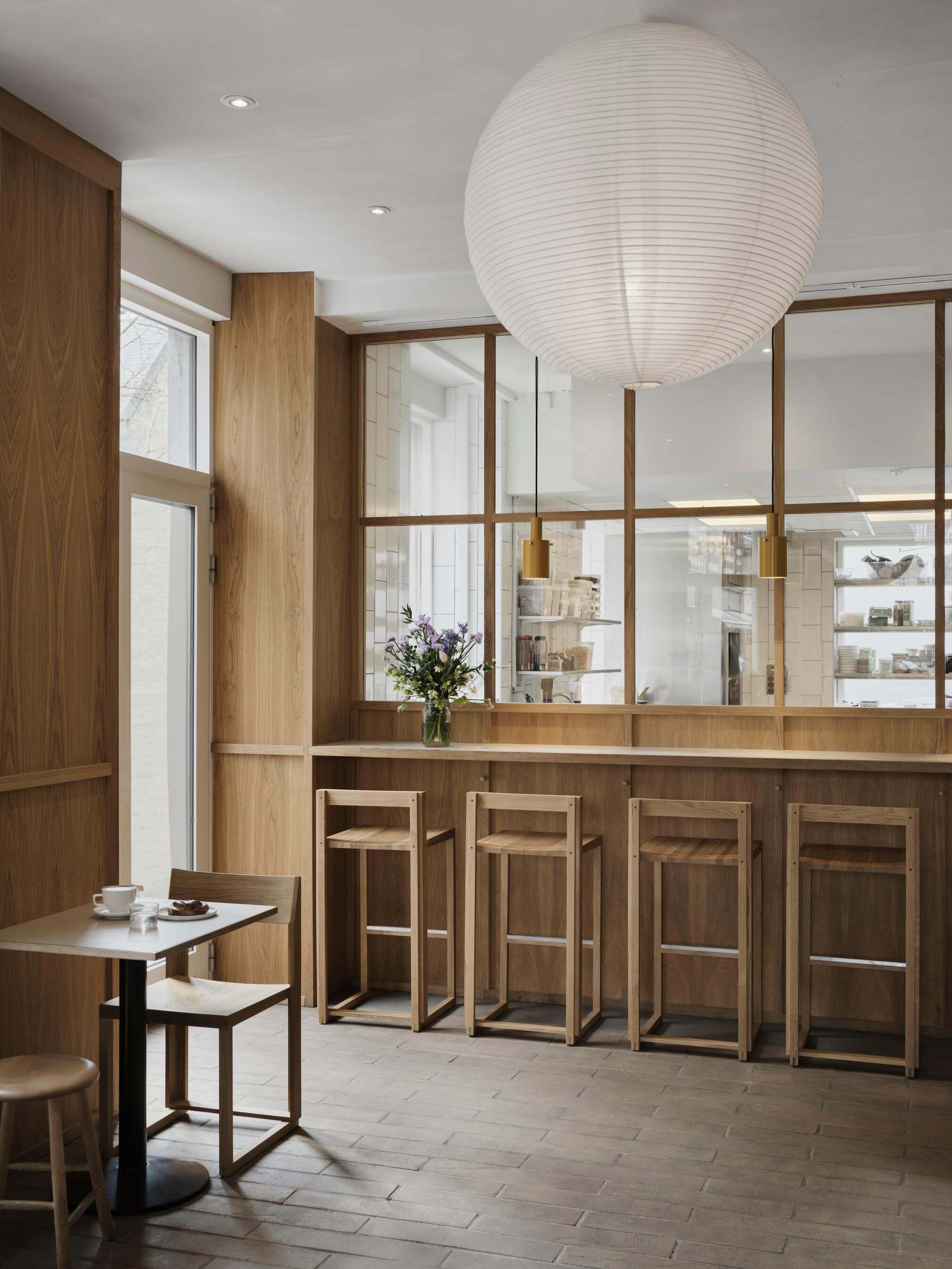 Luxury designer Outline Bar Chair High in modern kitchen setup, highlighting contemporary style and sustainable FSC®-certified oak craftsmanship.