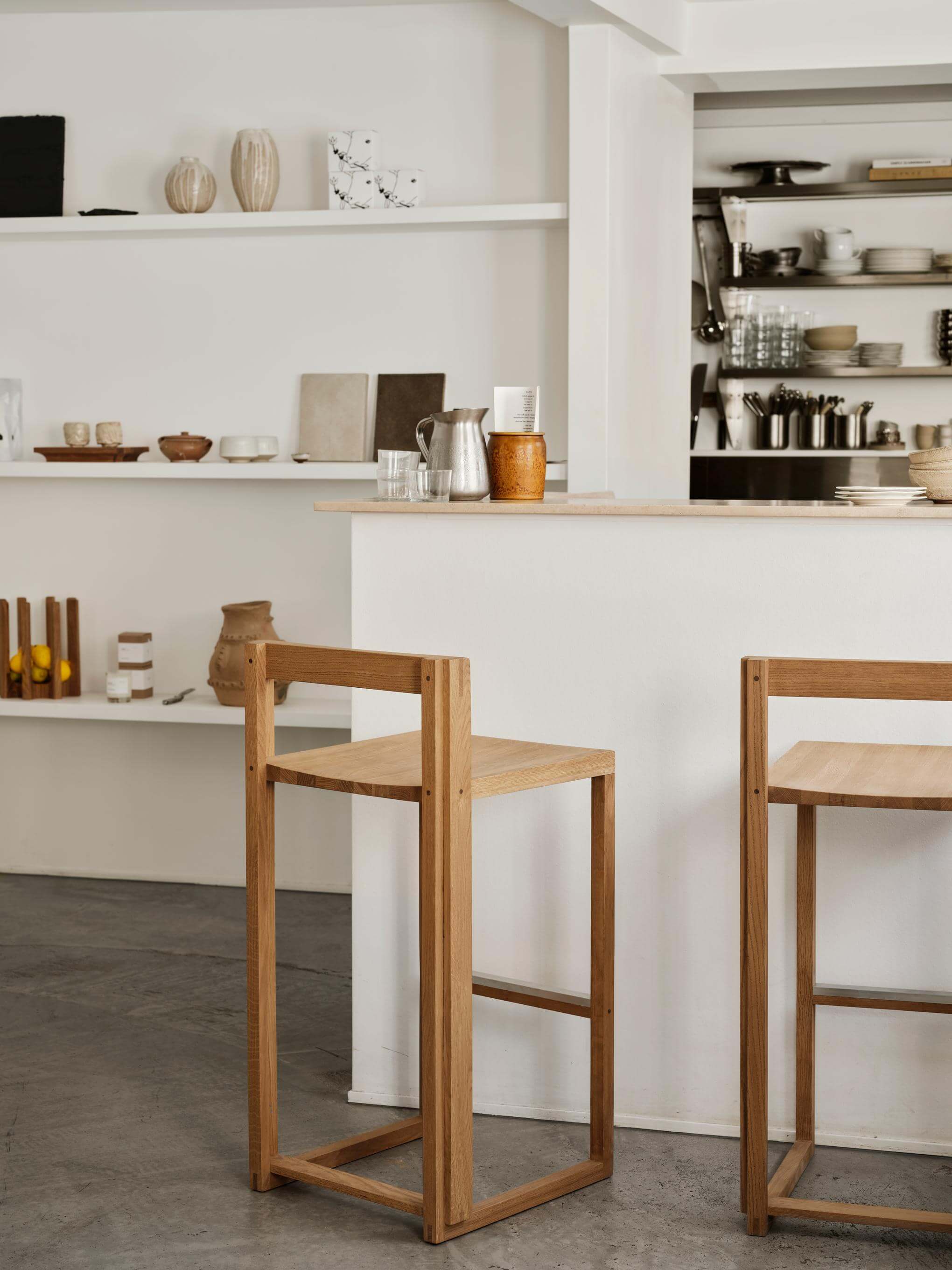 Outline Bar Chair High in a modern kitchen setting, showcasing luxury furniture design with FSC-certified oak. Premium home furnishings.