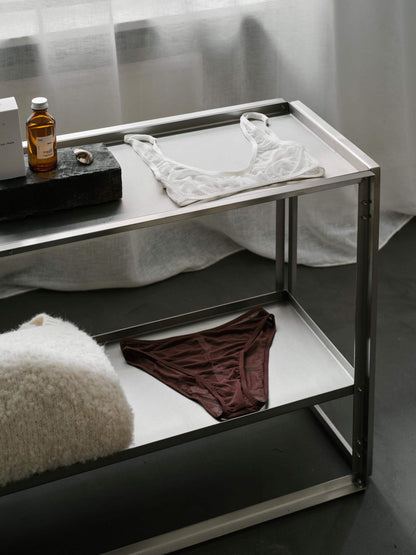 "Foldable Console with brushed stainless steel design, displaying minimalist decor, highlighting luxury and modern furniture collection."