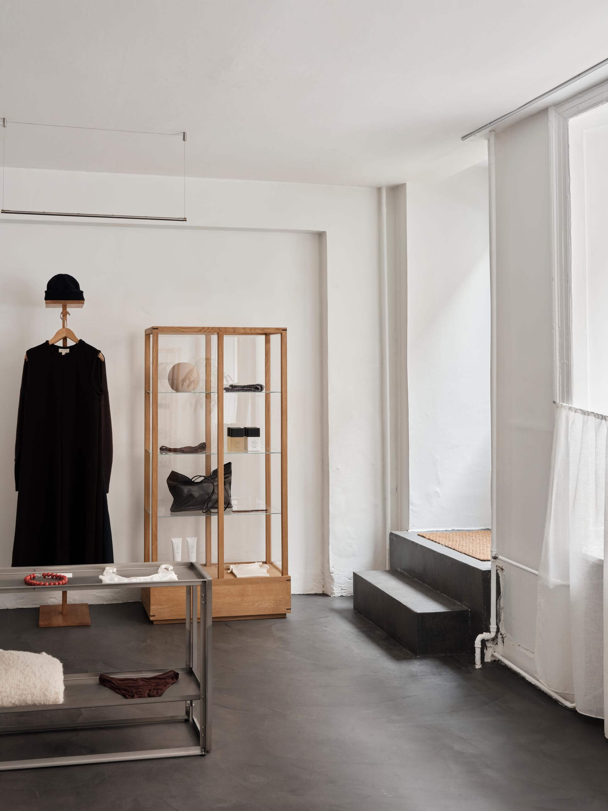 Minimalist modern loft with foldable console and showcase, embodying luxury and designer furniture aesthetics.