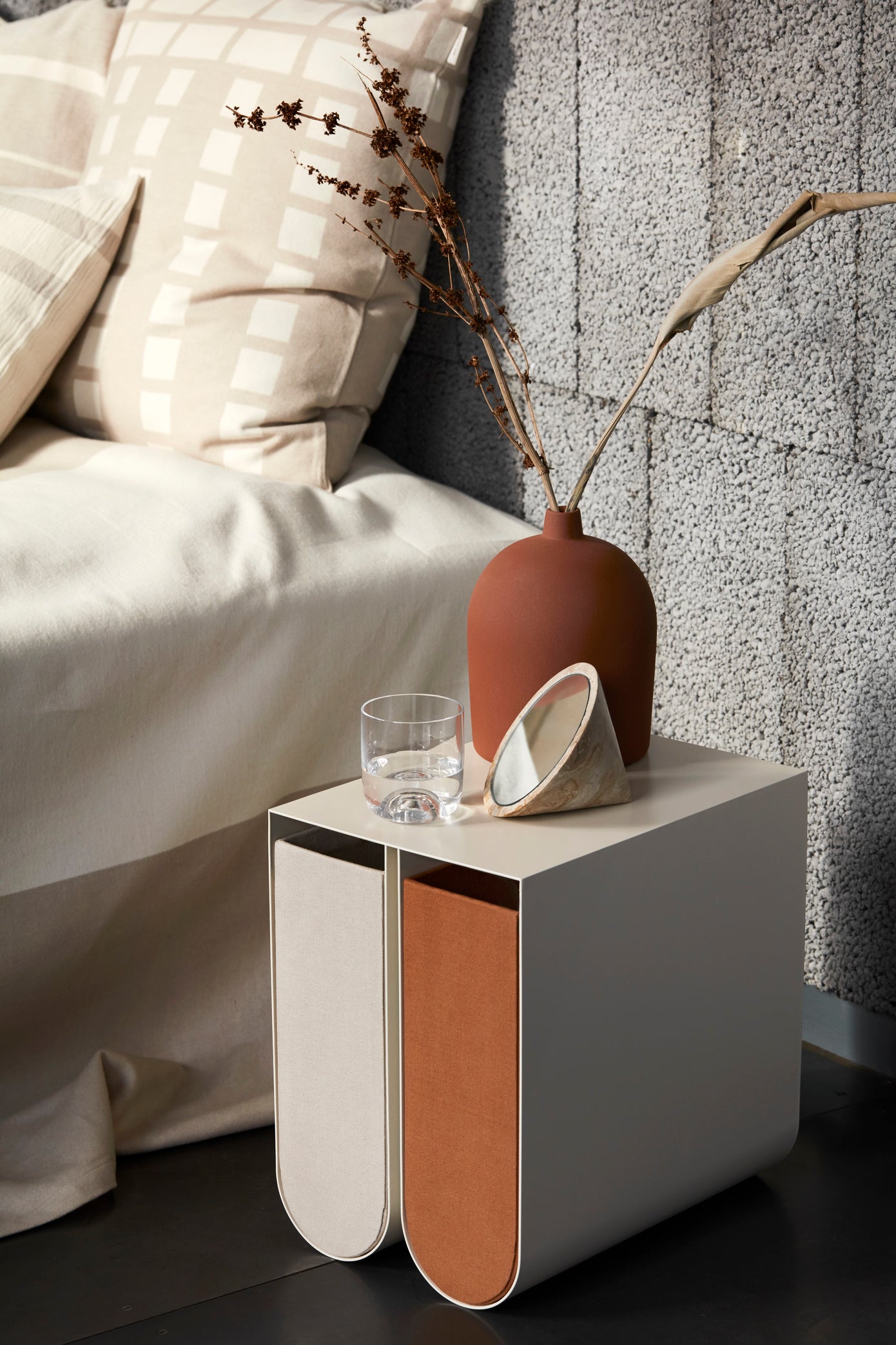 Luxury, modern curved side table by premium designer brand. Stylish U-shaped brushed stainless steel perfect for high-end home decor.