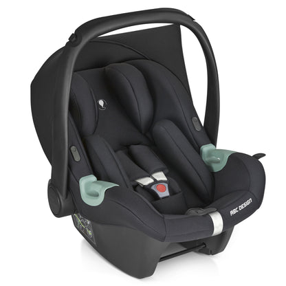 Black baby car seat with safety harness and handle, designed for infants, offering comfort and protection during travel.